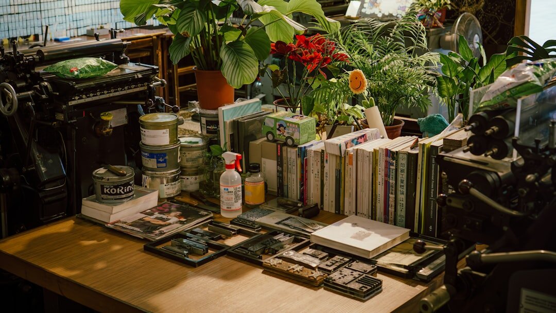 Documentary camera equipment, notebooks and film rolls on a wooden table