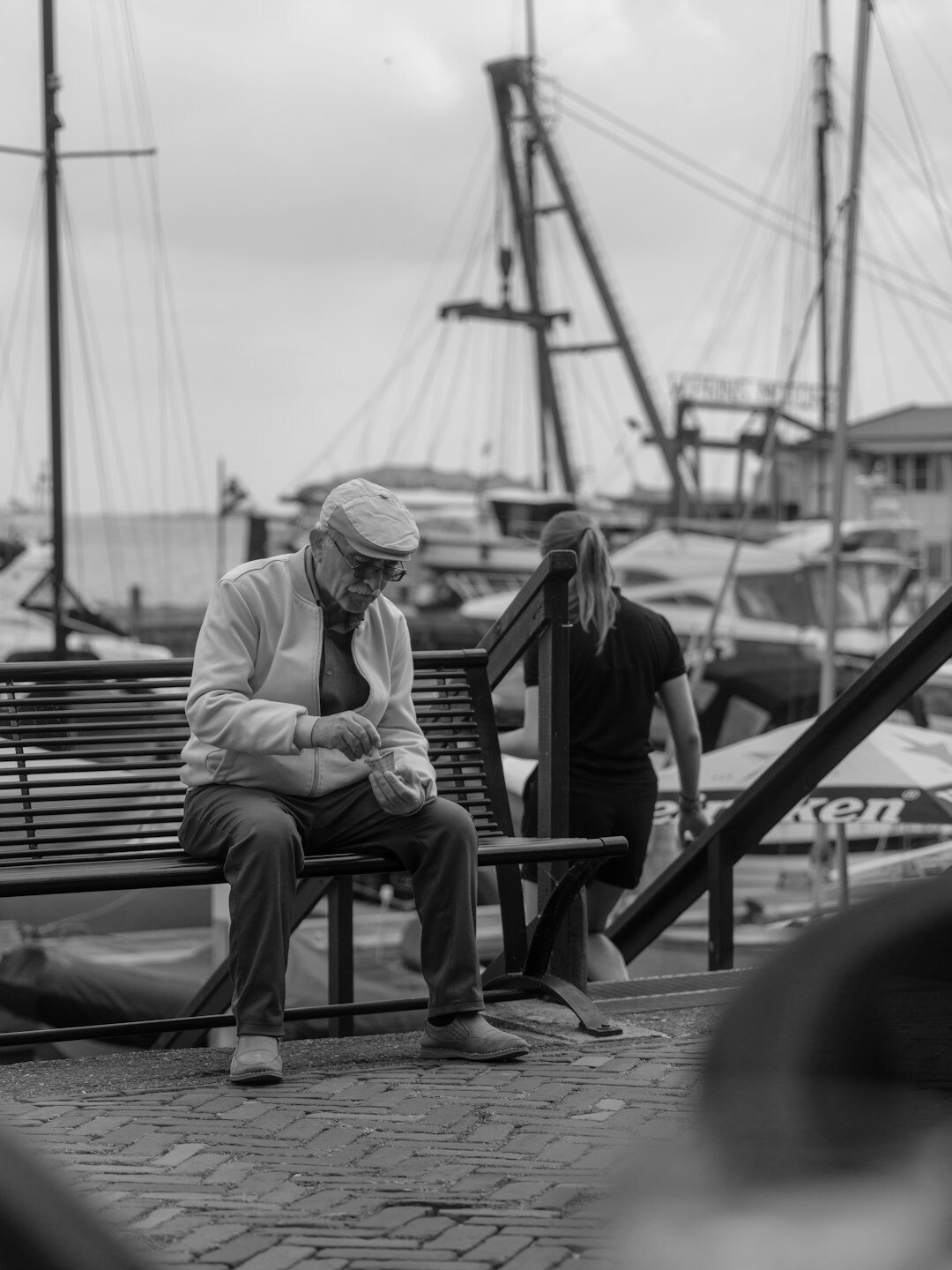 Danish documentary photographer talking with an elderly fisherman by the harbour
